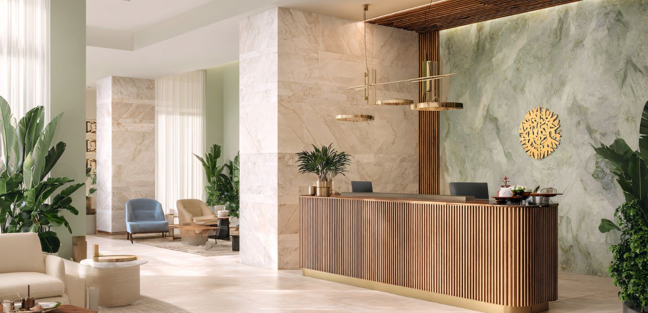 Hotel reception area with stone and wood feature wall design for durability and style
