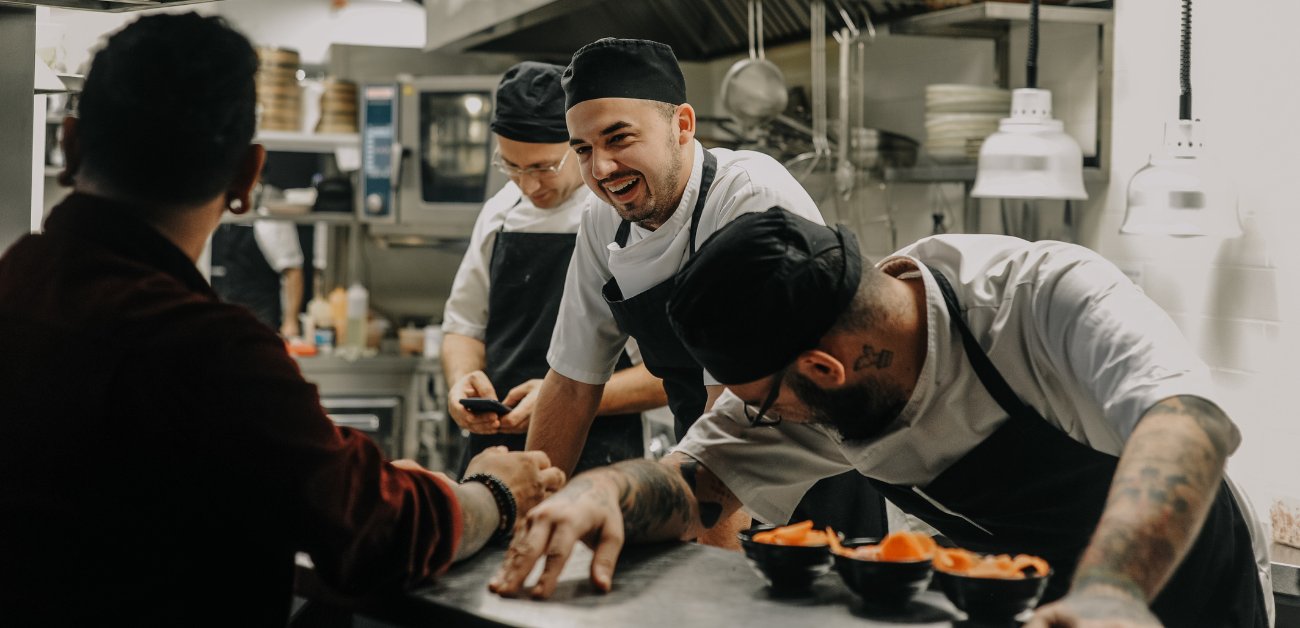 Chefs working in a commercial kitchen with safety-focused slip-resistant vinyl flooring