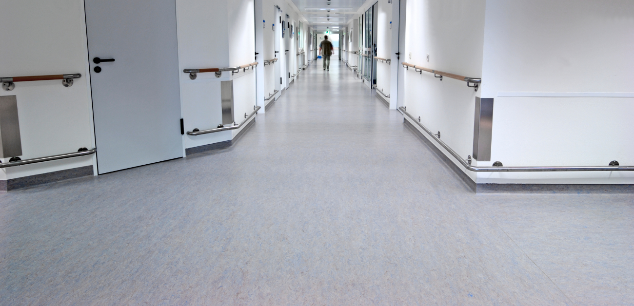 Hospital hallway with seamless vinyl flooring supporting hygiene and patient safety