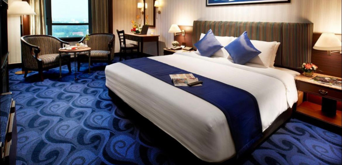Luxury hotel bedroom featuring premium carpet supplied for hospitality projects