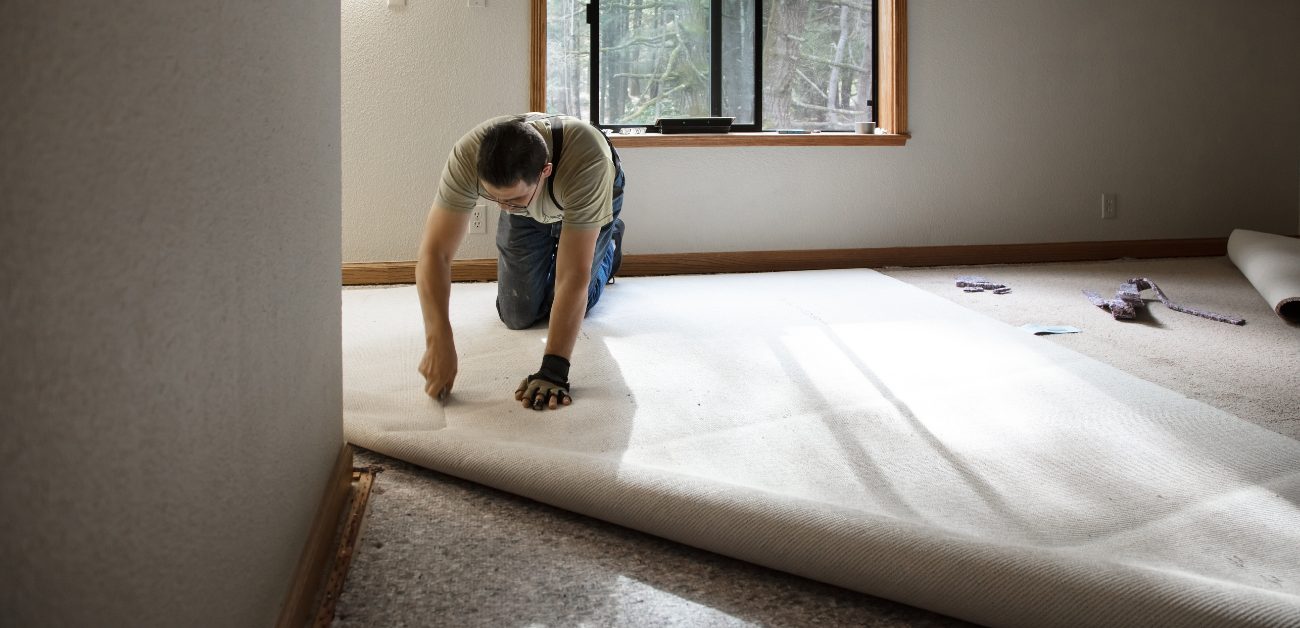 Professional installation of heavy-duty hotel carpet in a hospitality environment